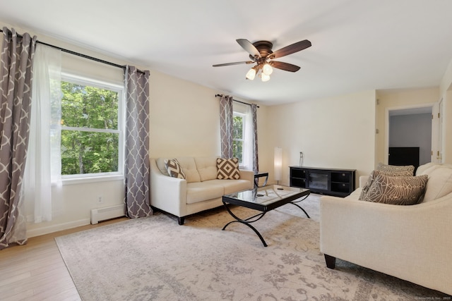 21 Dilaj Dr, Columbia, CT 06237 - living room featuring light wood-style flooring, a ceiling fan, baseboards, and a baseboard radiator