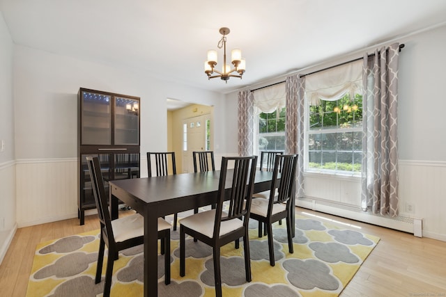 21 Dilaj Dr, Columbia, CT 06237 - dining space with a baseboard radiator, a wainscoted wall, a chandelier, and wood finished floors