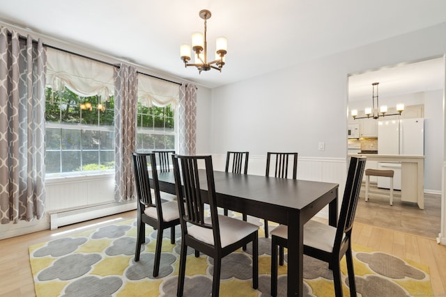 21 Dilaj Dr, Columbia, CT 06237 - dining space featuring a chandelier, a baseboard radiator, and light wood-style floors