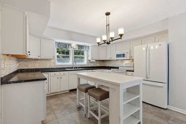 21 Dilaj Dr, Columbia, CT 06237 - kitchen with white appliances, a sink, backsplash, a chandelier, and dark countertops