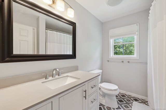 21 Dilaj Dr, Columbia, CT 06237 - bathroom with vanity, toilet, and baseboards