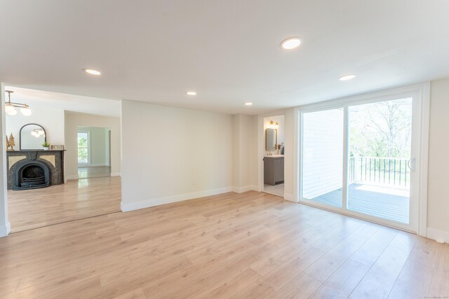 369 Thompson Rd, Thompson, CT 06277 - unfurnished living room with light wood finished floors, recessed lighting, and baseboards