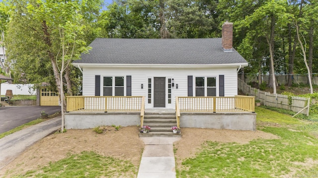452 New Haven Ave, Derby, CT 06418 - view of front of property with a chimney, a shingled roof, and a deck