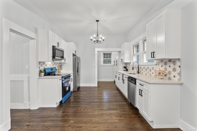 452 New Haven Ave, Derby, CT 06418 - kitchen with appliances with stainless steel finishes, a sink, a chandelier, light countertops, and dark wood-type flooring