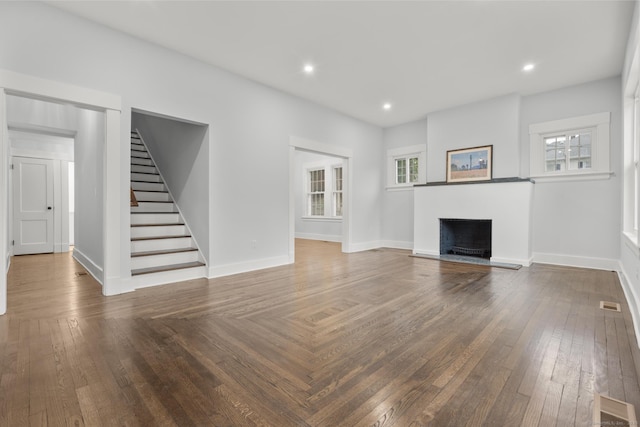 452 New Haven Ave, Derby, CT 06418 - unfurnished living room with stairs, a fireplace with flush hearth, healthy amount of natural light, baseboards, and recessed lighting