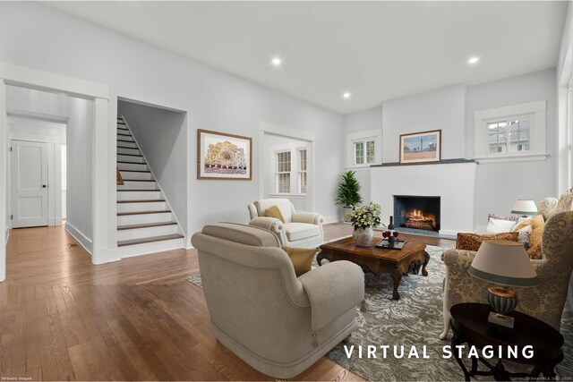 452 New Haven Ave, Derby, CT 06418 - living room with stairs, wood finished floors, a lit fireplace, recessed lighting, and baseboards