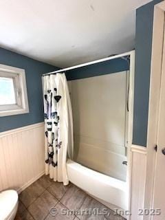 64 Hayes Rd, Simsbury, CT 06081 - full bath featuring shower / bath combination with curtain, a wainscoted wall, and tile patterned flooring