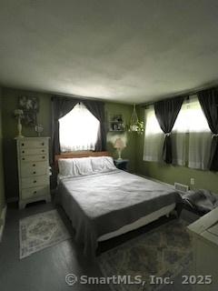 64 Hayes Rd, Simsbury, CT 06081 - bedroom with multiple windows and wood finished floors