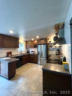 64 Hayes Rd, Simsbury, CT 06081 - kitchen with stainless steel refrigerator with ice dispenser, exhaust hood, dark countertops, dark brown cabinets, and range