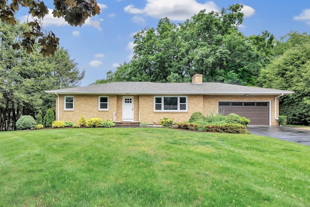 325 River Rd, Hamden, CT 06518 - single story home with asphalt driveway, a garage, a chimney, a front yard, and brick siding