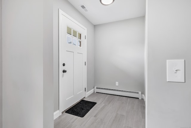 325 River Rd, Hamden, CT 06518 - foyer featuring a baseboard radiator, baseboards, and wood tiled floors