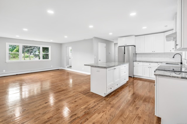 325 River Rd, Hamden, CT 06518 - kitchen with freestanding refrigerator, a sink, light stone countertops, a kitchen island, and recessed lighting