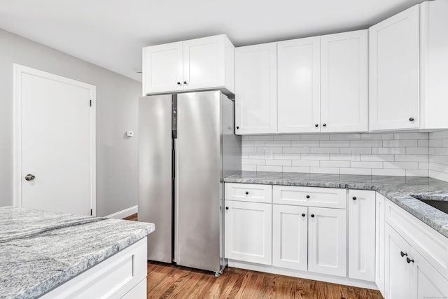325 River Rd, Hamden, CT 06518 - kitchen with freestanding refrigerator, light stone countertops, and white cabinetry