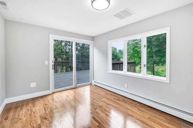325 River Rd, Hamden, CT 06518 - spare room featuring baseboard heating, wood finished floors, and baseboards