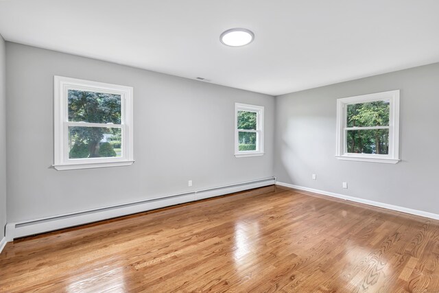 325 River Rd, Hamden, CT 06518 - empty room with a baseboard radiator, wood finished floors, and baseboards