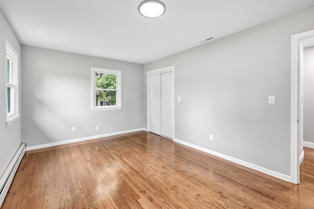 325 River Rd, Hamden, CT 06518 - empty room with baseboard heating, wood finished floors, and baseboards