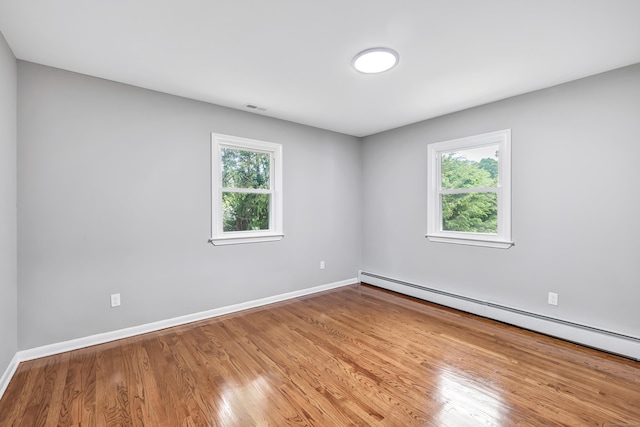 325 River Rd, Hamden, CT 06518 - spare room with a baseboard heating unit, wood finished floors, and baseboards