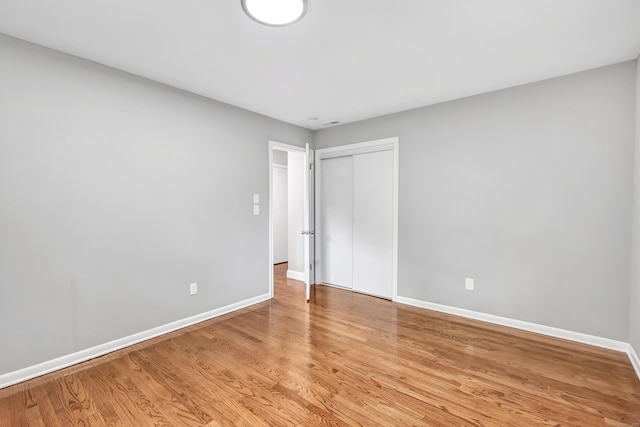 325 River Rd, Hamden, CT 06518 - unfurnished bedroom with baseboards, light wood-type flooring, and a closet