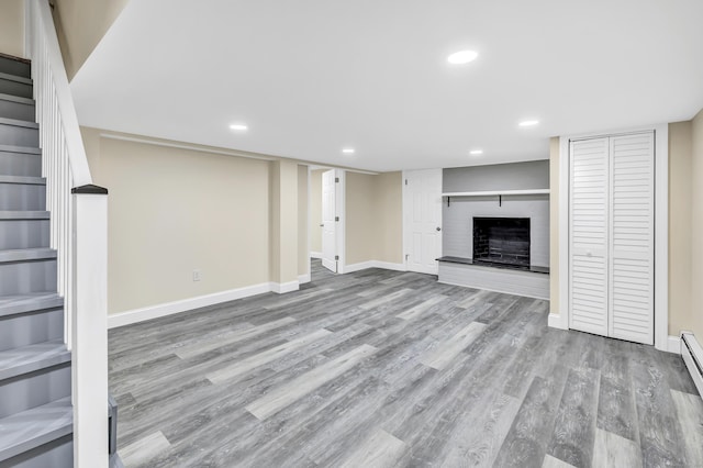 325 River Rd, Hamden, CT 06518 - unfurnished living room with stairs, wood finished floors, recessed lighting, baseboards, and a fireplace