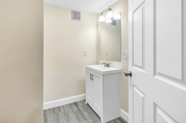 325 River Rd, Hamden, CT 06518 - bathroom featuring vanity, wood finished floors, and baseboards