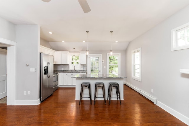 15 Seneca Rd, Middlefield, CT 06455 - kitchen featuring stainless steel appliances, baseboard heating, a kitchen breakfast bar, light stone countertops, and white cabinetry