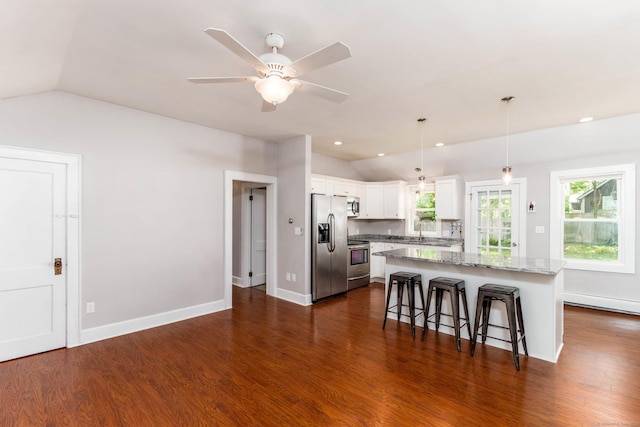 15 Seneca Rd, Middlefield, CT 06455 - kitchen featuring vaulted ceiling, stainless steel appliances, a breakfast bar, white cabinets, and light stone countertops