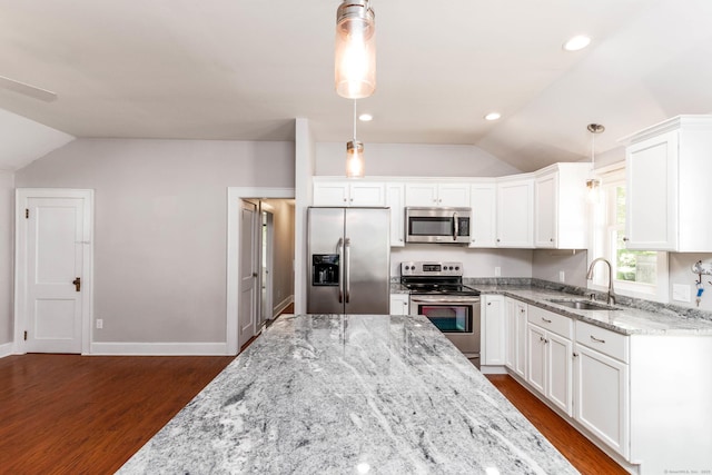 15 Seneca Rd, Middlefield, CT 06455 - kitchen featuring appliances with stainless steel finishes, a sink, vaulted ceiling, dark wood finished floors, and white cabinetry