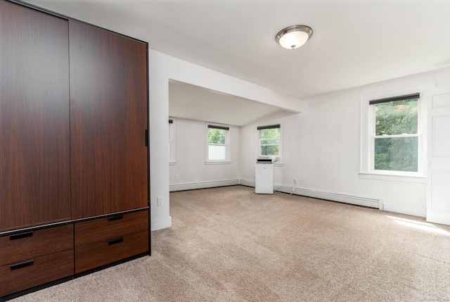 15 Seneca Rd, Middlefield, CT 06455 - unfurnished living room with a baseboard heating unit, light colored carpet, vaulted ceiling, and baseboards