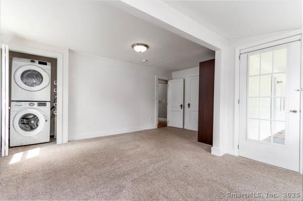 15 Seneca Rd, Middlefield, CT 06455 - laundry room with stacked washer and clothes dryer, carpet, and baseboards