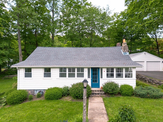 15 Seneca Rd, Middlefield, CT 06455 - view of front of property featuring a detached garage, a chimney, an outbuilding, a front lawn, and roof with shingles