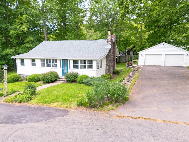 15 Seneca Rd, Middlefield, CT 06455 - ranch-style home featuring a chimney, a garage, an outdoor structure, view of wooded area, and a front lawn