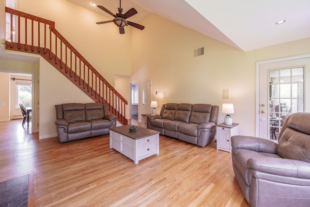 97 Spring Wood Ln, Bloomfield, CT 06002 - living room with light wood finished floors, ceiling fan, stairway, high vaulted ceiling, and a baseboard heating unit