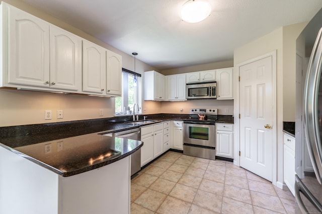 97 Spring Wood Ln, Bloomfield, CT 06002 - kitchen with appliances with stainless steel finishes, a peninsula, a sink, and white cabinets