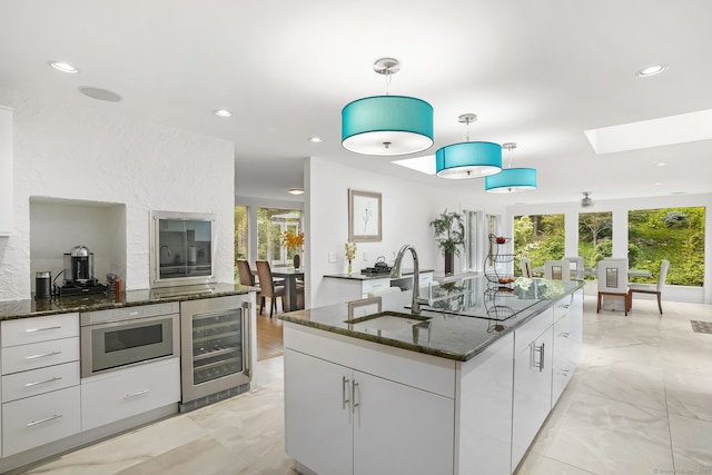 227 Dublin Hill Rd, Southbury, CT 06488 - kitchen with wine cooler, a sink, a skylight, healthy amount of natural light, and recessed lighting
