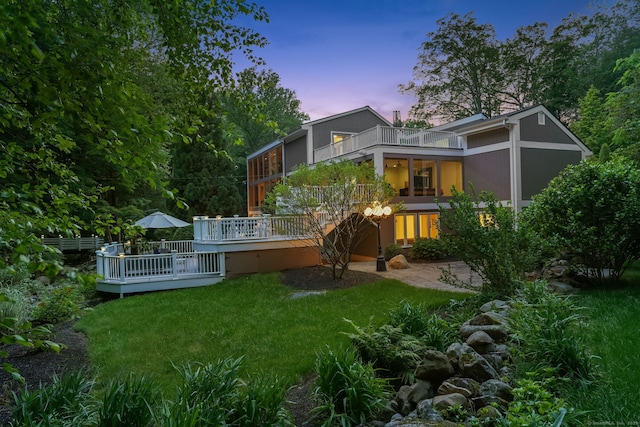227 Dublin Hill Rd, Southbury, CT 06488 - back of property at dusk with a deck and a lawn