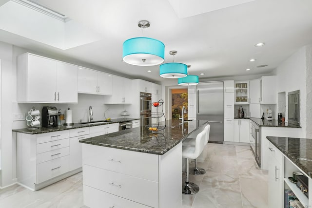227 Dublin Hill Rd, Southbury, CT 06488 - kitchen with a sink, stainless steel appliances, light marble finish floors, recessed lighting, and white cabinetry