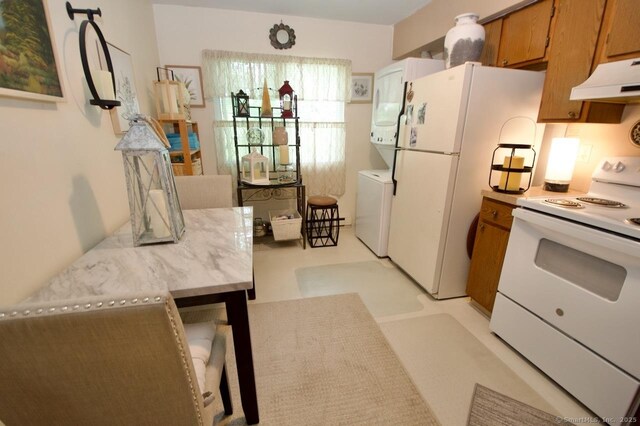 35 Mountain Village Rd Unit 15, Waterbury, CT 06706 - kitchen with white appliances, extractor fan, washer / dryer, brown cabinetry, and light countertops