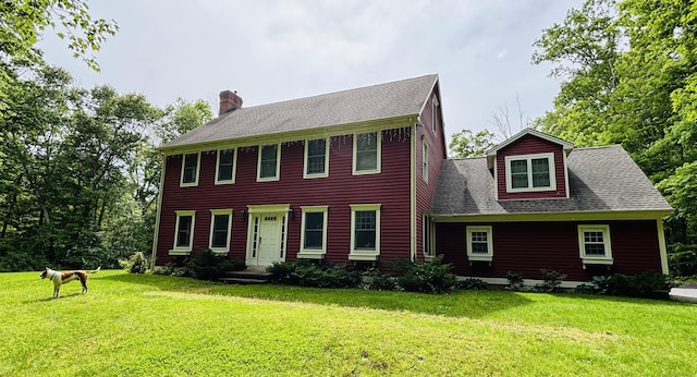 676 Deep River Rd, Colchester, CT 06415 - colonial home featuring a chimney, a front yard, and a shingled roof
