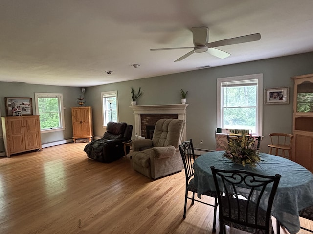 676 Deep River Rd, Colchester, CT 06415 - dining room featuring light wood-type flooring, plenty of natural light, ceiling fan, and a fireplace