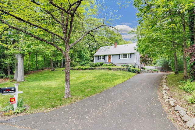 91 Bart Rd, Monroe, CT 06468 - view of front of home featuring a chimney, a front lawn, and asphalt driveway