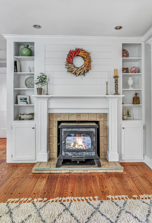 91 Bart Rd, Monroe, CT 06468 - detailed view of wood finished floors, built in shelves, and a wood stove