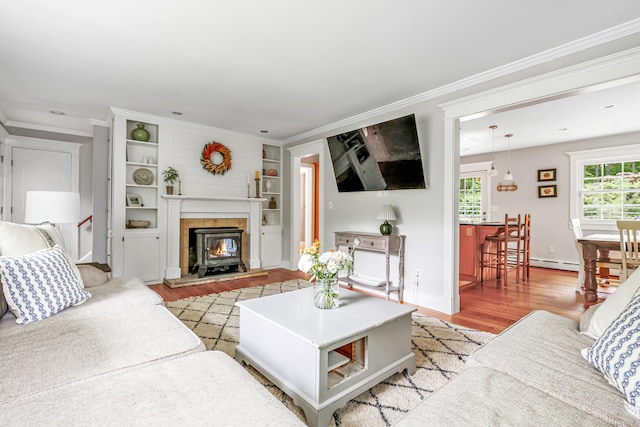 91 Bart Rd, Monroe, CT 06468 - living area with light wood-type flooring, crown molding, built in features, and baseboards
