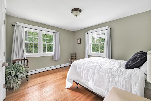 91 Bart Rd, Monroe, CT 06468 - bedroom featuring a baseboard heating unit, multiple windows, wood finished floors, and baseboards