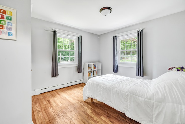 91 Bart Rd, Monroe, CT 06468 - bedroom with a baseboard heating unit, multiple windows, and wood finished floors