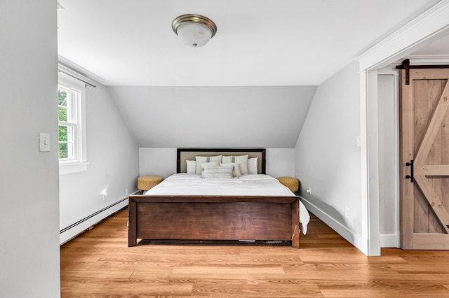 91 Bart Rd, Monroe, CT 06468 - bedroom featuring a baseboard heating unit, a barn door, vaulted ceiling, light wood-style floors, and baseboards