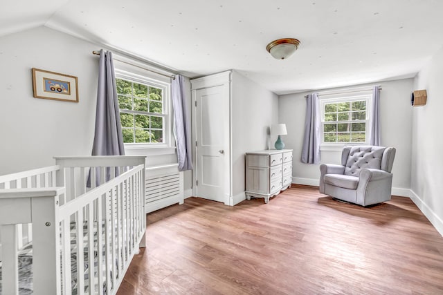 91 Bart Rd, Monroe, CT 06468 - bedroom featuring wood finished floors, vaulted ceiling, a crib, and baseboards