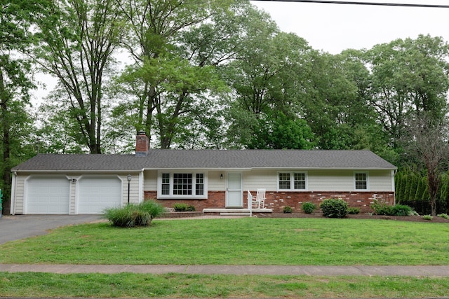 792 Cornwall Ave, Cheshire, CT 06410 - single story home featuring asphalt driveway, an attached garage, a chimney, brick siding, and a front yard