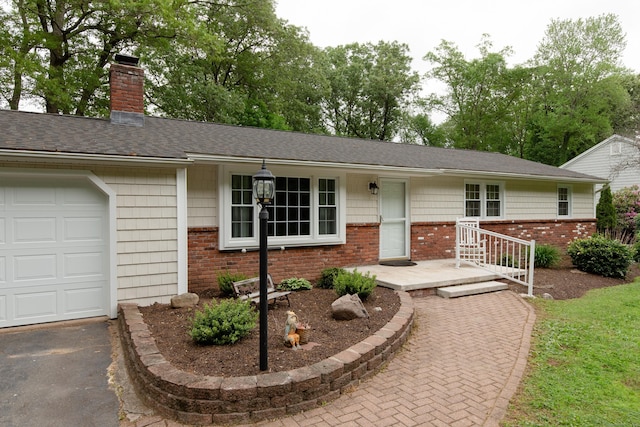 792 Cornwall Ave, Cheshire, CT 06410 - single story home featuring brick siding, a chimney, a garage, asphalt driveway, and roof with shingles