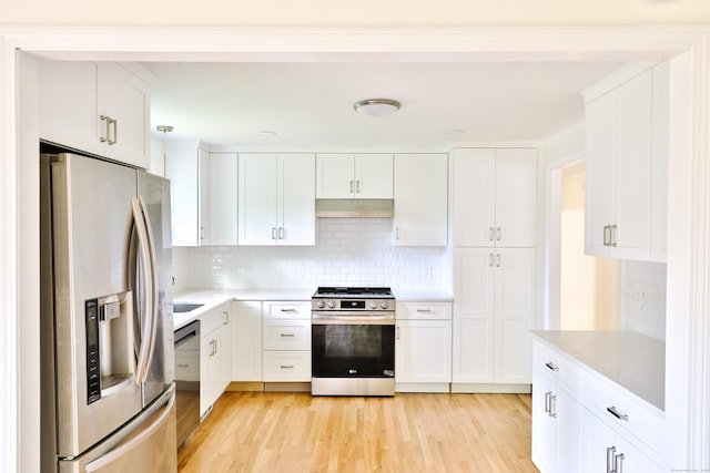 792 Cornwall Ave, Cheshire, CT 06410 - kitchen featuring appliances with stainless steel finishes, light countertops, tasteful backsplash, under cabinet range hood, and light wood finished floors