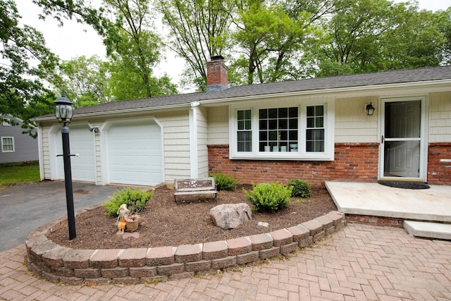 792 Cornwall Ave, Cheshire, CT 06410 - ranch-style home with brick siding, asphalt driveway, a garage, and a chimney